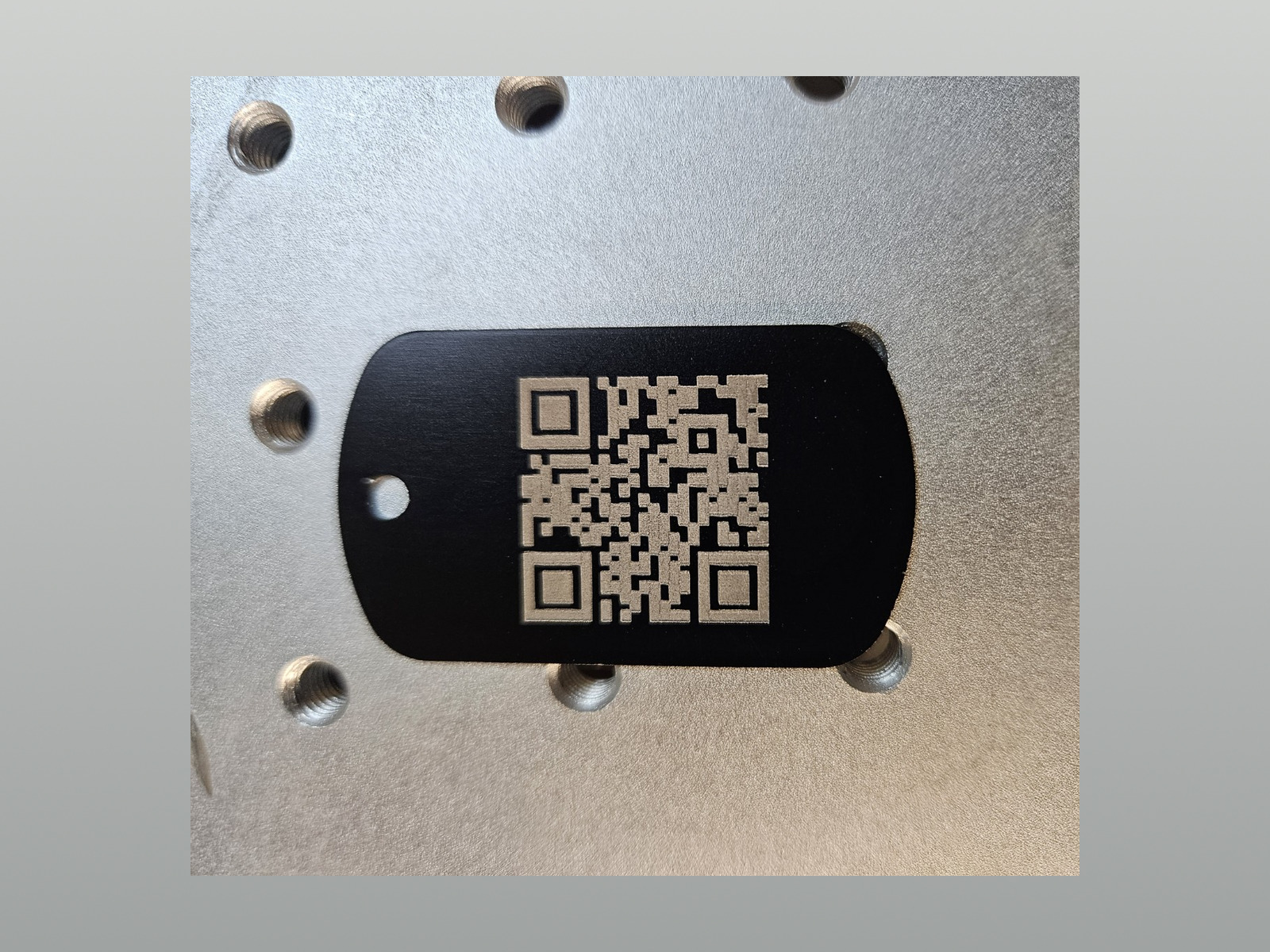Black stainless steel key tag engraved with a QR code